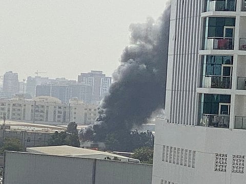 Smoke billowing out of the warehouse that caught fire in Sharjah on Sunday.