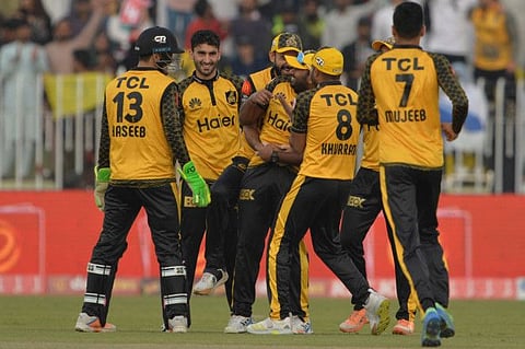 Peshawar Zalmi's players celebrate the wicket of Islamabad United's Asif Ali (not pictured) during the Pakistan Super League (PSL) Twenty20 cricket match at the Rawalpindi Cricket Stadium, in Rawalpindi.