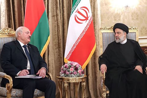 A handout picture provided by the Iranian presidency shows Iran's President Ebrahim Raisi (R) meeting with Belarus President Alexander Lukashenko in Tehran on March 13, 2023.