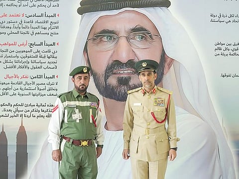 Lieutenant General Abdullah Khalifa Al Marri, Commander-in-chief of Dubai Police, with 1st Corporal Abdul Rahman Ibrahim Mohammad from the General Department of Traffic.