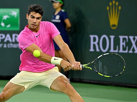 Carlos Alcaraz hits a shot in his fourth round match against Jack Draper in the BNP Paribas Open at the Indian Wells Tennis Garden. Draper retired due to injury.