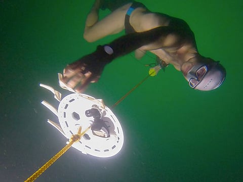 Czech freediver David Vencl reaches 52 metres under the ice of Lake Sils in one breath and wearing only a swimsuit in this picture taken from a video in Sils near St. Moritz, Switzerland. 