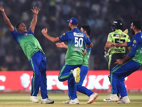 Multan Sultans' Sheldon Cottrell (left) celebrates the wicket of Lahore Qalandars' Abdullah Shafique during the Pakistan Super League qualifier on Wednesday.