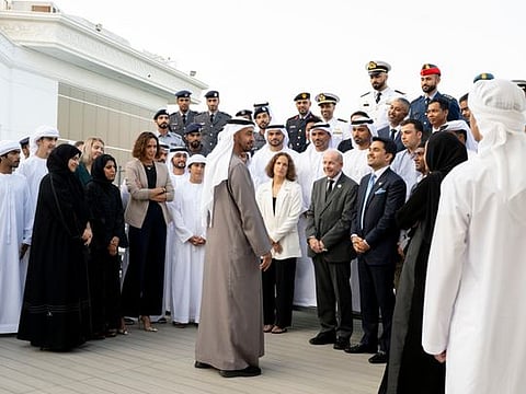 President His Highness Sheikh Mohamed bin Zayed Al Nahyan (centre) speaks with members of Swim 62 Group, during a Sea Palace barza