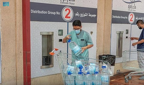 Employees handle Zamzam packs. 