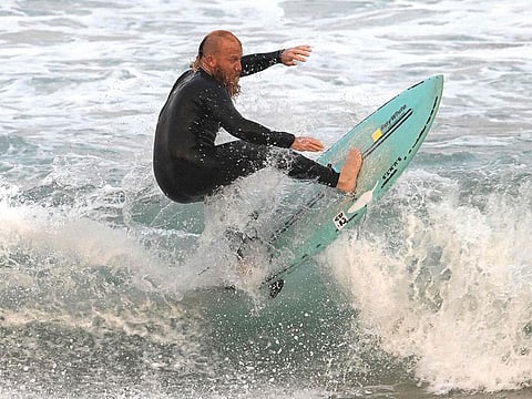 Blake Johnston surfs as he is setting out to break the world record for the longest surfing session on Cronulla Beach in Sydney on March 17, 2023.  