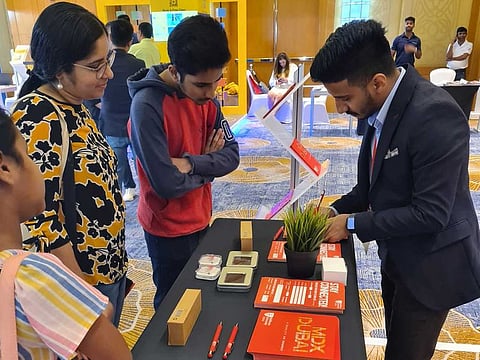 Dubai-based parent Sandhya Nair and her children exploring courses at Gulf News Edufair 