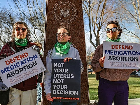 Members of the Women's March group protest in support of access to abortion medication outside the Federal Courthouse on Wednesday, March 15, 2023 in Amarillo, Texas. 