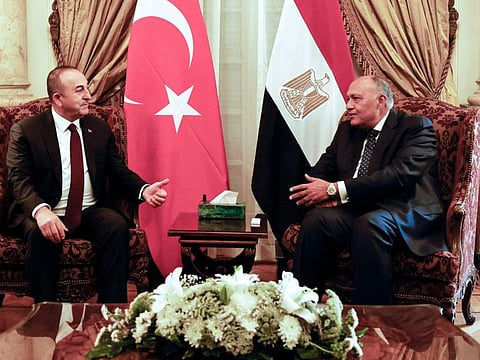 Egypt's Foreign Minister Sameh Shoukry (right) meets his Turkish counterpart Mevlut Cavusoglu in Cairo on March 18, 2023.  