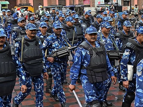 India's Rapid Action Force (RAF) personnel patrol along a street during a hunt for Sikh separatist, in Amritsar on March 20, 2023. 