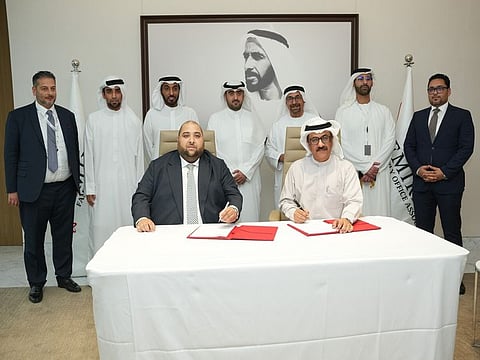 (Sitting) Adam Ladjadj, Chairman of the Emirates Family Office Association and Jamal Aljarwan, Secretary General - UAE International Investors Council (UAEIIC) signing the MoU (standing from left) Imran Khan  and Fahad Ahbabi, Co-founders of the Emirates Family Office Association, ADGM CEO, Dhaher Bin Dhaher Al Mheiri, Mohamed Al Sabah, Nasser Al Nowais, Chairman of Rotana Hotel Management Corporation PJSC and Aswaq Management, and Ahmed Nasser Al Nowais 