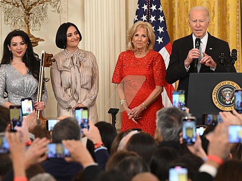 Musician Sahba Motallebi, Iranian-US singer-songwriter Rana Mansour, and US First Lady Jill Biden look on as US President Joe Biden speaks during a Nowruz reception in the East Room of the White House in Washington, DC, on March 20, 2023.  