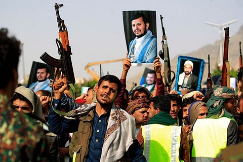 Supporters of Yemen's Houthi militia raising portraits of their leader Abdul Malik Al Houthi during a rally in the capital Sana'a.