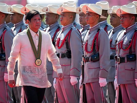 Philippine President Ferdinand Marcos Jr. walks beside Filipino troopers during rites at the 126th founding anniversary of the Philippine Army at Fort Bonifacio in Taguig, Philippines on Wednesday, March 22, 2023.