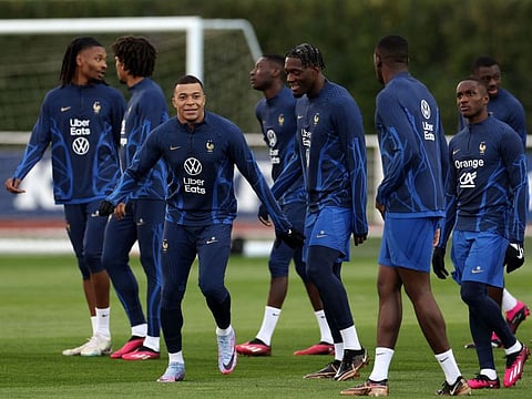 France's forward Kylian Mbappe (centre) smiles during a training session in Clairefontaine-en-Yvelines, ahead of the Euro 2024 qualifiers.