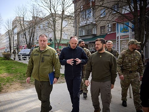 Ukraine's President Volodymyr Zelensky walks along a street, amid Russia's attack on Ukraine, as he visits Kherson, Ukraine March 23, 2023. 