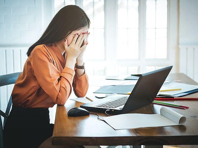 Upset woman in front of a laptop