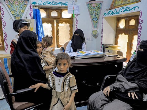 Women wait with children before medical examinations at Al Janatain Charity Medical Centre, which helps the impoverished, in Yemen's Houthi-rebel-held capital Sana'a on March 14, 2023.  