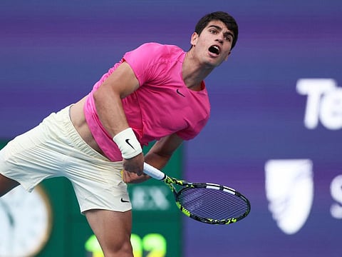 Carlos Alcaraz of Spain serves against Facundo Bagnis of Argentina in their second round match at Hard Rock Stadium in Miami Gardens, Florida.