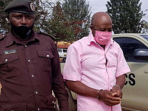 (File photo) Paul Rusesabagina, portrayed as a hero in a Hollywood movie about Rwanda's 1994 genocide, is escorted in handcuffs into a courtroom, in Kigali, Rwanda October 20, 2020. 