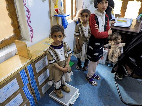 A child's weight is measured during a medical examination at Al Janatain Charity Medical Centre, which helps the impoverished, in Sana'a.