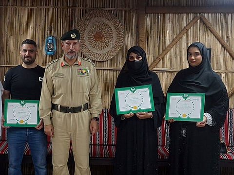 Farid Talal Al Gohary (left) and the two RTA employees, Fatima Bilal Mohammed and Khawla Ali Saleh, during a ceremony by Dubai Police to honour them