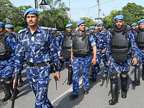 India's Rapid Action Force (RAF) personnel patrol along a street during a hunt for Sikh separatist, in Amritsar on March 23, 2023.  