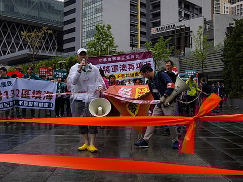 Protesters wearing number tags during a rally in Hong Kong, Sunday, March 26, 2023.