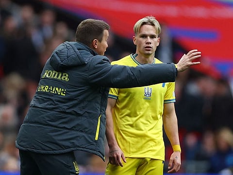 Ukraine interim coach Ruslan Rotan (left) talks to Mykhailo Mudryk during a break in play against England during the Euro 2024 qualifier at Wembley, London.