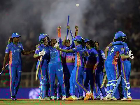 Mumbai Indians players celebrate after defeating Delhi Capitals in the Women’s Premier League final at Brabourne Stadium on Sunday.