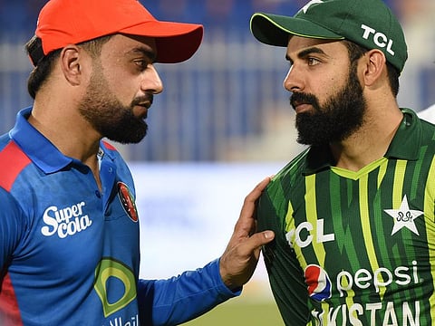 Pakistan captain Shadab Khan (right) with Afghanistan captain Rashid Khan.