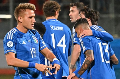 Italy's forward Mateo Retegui (left) celebrates after scoring during the UEFA Euro 2024 Group C qualification match against Malta at the National stadium in Ta'Qali, Malta.