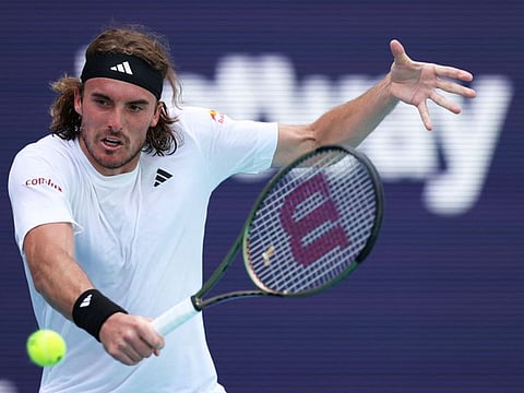 Stefanos Tsitsipas of Greece plays a backhand against Cristian Garin of Chile in their third round match at Hard Rock Stadium in Miami Gardens, Florida.