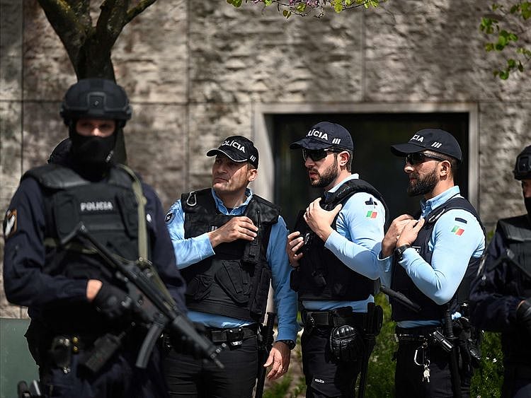 Portuguese police officers stand guard in front of the Ismaili Islamic centre in Lisbon, after two people died following a knife attack that wounded several others, on March 28, 2023.
