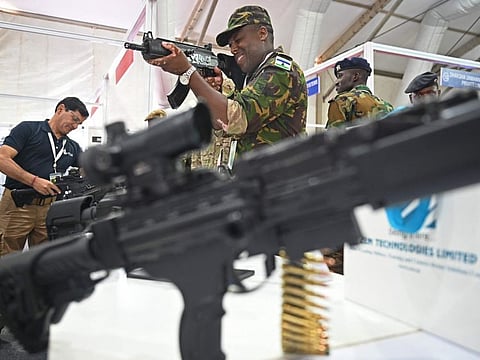 An African Army soldier checks a weapon at the weapon display session during Africa-India field training exercise (AFINDEX-2023), in Pune on March 29, 2023.