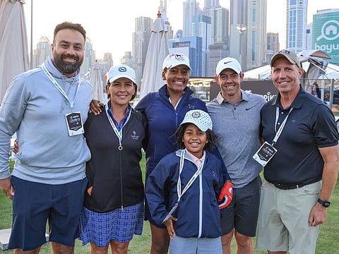 Maya Palanza Gaudin (Centre) with Rory McIlroy, her parents, younger sister Rouda Willa and coach Yasin Ali (left) meet up at the Dubai Desert Classic at Emirates Golf Club earlier this year