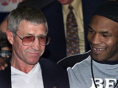 In this file photo taken on June 23, 2000, former world champion boxer Ken Buchanan (L) is embraced by US Mike Tyson (R) before the latter weighed-in at 221 pounds in Glasgow 23 June 2000 for his bout with compatriot Lou Savarese in Glasgow