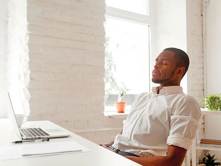 Man meditating at his desk