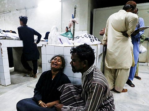 People mourn the death of a relative, who was killed along with others in a stampede during handout distribution, at a hospital morgue in Karachi, Pakistan March 31, 2023.  