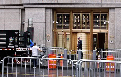 Workers with the NYPD set up barricades outside the offices of the Manhattan District Attorney on April 1, 2023 in New York City.  