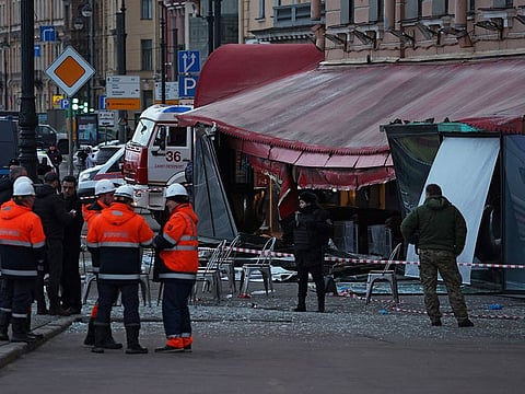 Investigators and members of emergency services work at the site of an explosion in a cafe in Saint Petersburg, Russia.