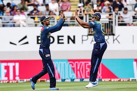 Sri Lanka's Maheesh Theekshana (right) congratulates teammate Nuwanidu Fernando on taking the catch of New Zealand's Tom Latham during the first Twenty 20 international at Eden Park in Auckland.
