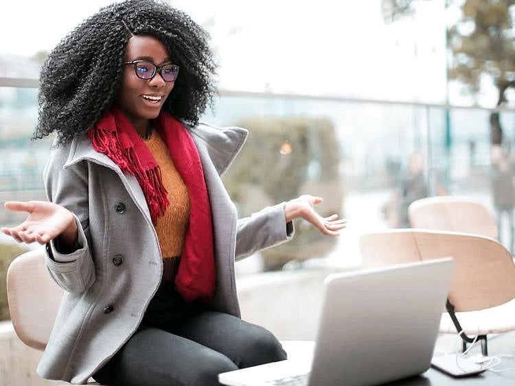A woman happy in front of her laptop