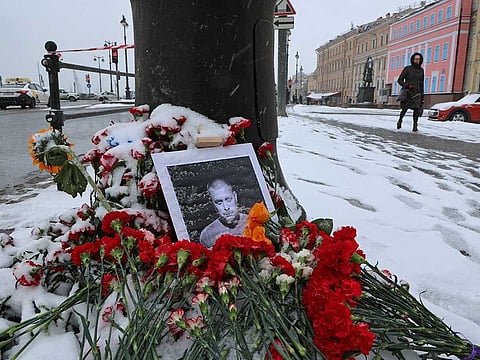 A portrait of Russian military blogger Vladlen Tatarsky, (real name Maxim Fomin), who was killed in the cafe explosion the day before, is placed among flowers near the blast site in Saint Petersburg, Russia April 3, 2023.