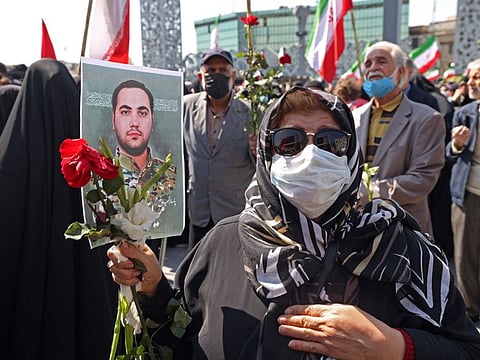 Mourners attend the funeral procession for two of Iran's revolutionary guard forces killed by Israel in Syria, held in Tehran on April 4, 2023.  