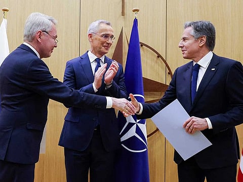 Finnish Foreign Minister Pekka Haavisto, left, shakes hands with United States Secretary of State Antony Blinken, right, after handing over his nation's accession document during a meeting of NATO foreign ministers at NATO headquarters in Brussels, Tuesday, April 4, 2023.  