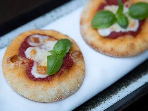 Italian-style manakish, spicy tomato sauce and smoked mozzarella cheese