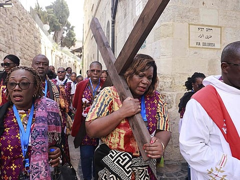 Pilgrims carry a wooden cross along the Via Dolorosa (Way of Suffering) in Jerusalem's Old City during the Catholic Good Friday procession. For illustrative purposes only.
