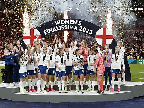 England players celebrate with the trophy after winning the Women's Finalissima against Brazil at Wembley Stadium, London.