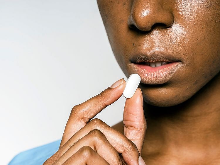 Woman eating a tablet
